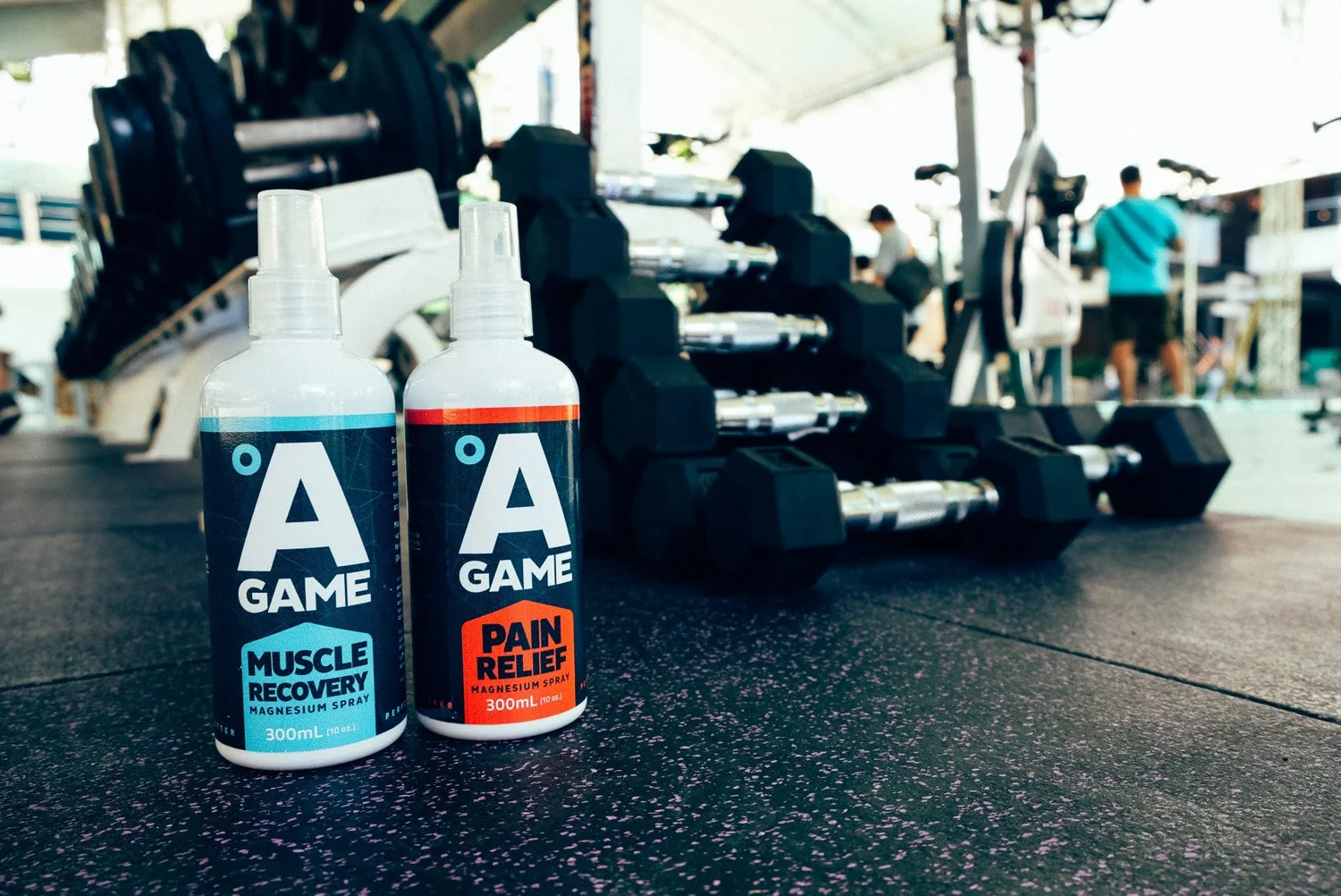 A-Game Muscle Recovery and Pain Relief sprays beside training equipment